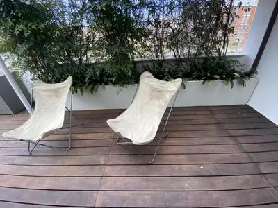 two white chairs sitting on top of a patio at La terrazza di Baccio - Baccio's Terrace in Rome