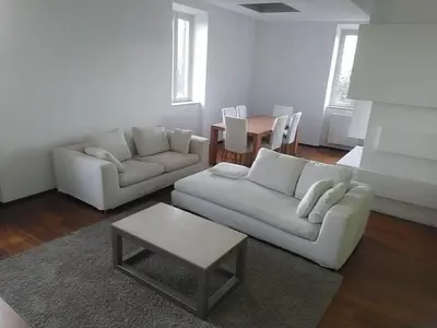 a living room with a white couch and a table at La terrazza di Baccio - Baccio's Terrace in Rome
