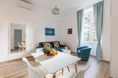 a living room with a white table and chairs at Hostly-The Porta Pia Suite-Rome Centre with Charme in Rome