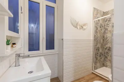 a white bathroom with a sink and a shower at Hostly-The Porta Pia Suite-Rome Centre with Charme in Rome