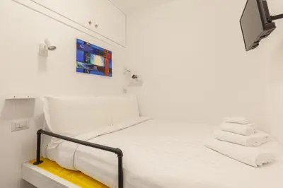 a white bedroom with a white bed with white sheets at Hostly-The Porta Pia Suite-Rome Centre with Charme in Rome