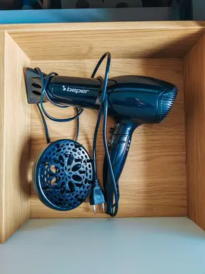 a black hairdryer in a wooden box at La Casetta A Monti Di Creta in Rome