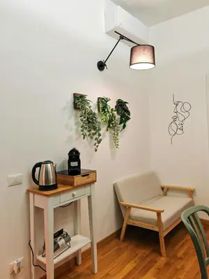 a room with a table and a table and a chair at La Casetta A Monti Di Creta in Rome