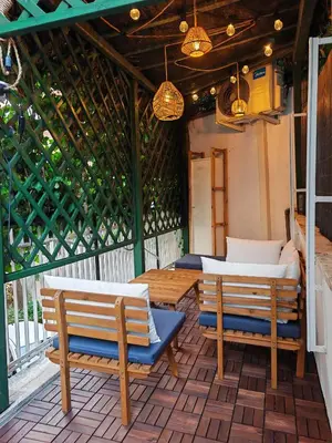 a patio with two beds and two chairs and lights at La Casetta A Monti Di Creta in Rome