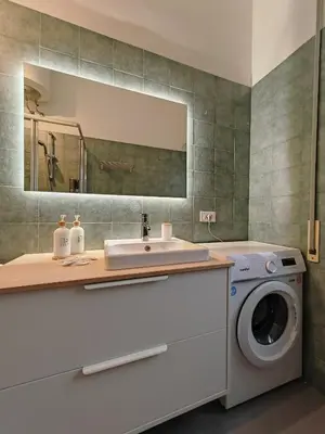 a bathroom with a washing machine and a sink at La Casetta A Monti Di Creta in Rome