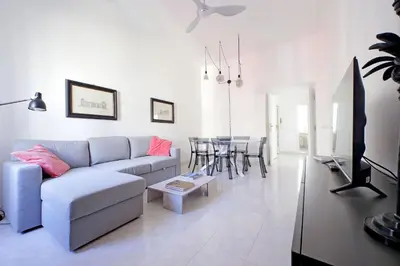 a living room with a couch and a table at New Comfortable 2 Br Della Vittoria by Halldis in Rome