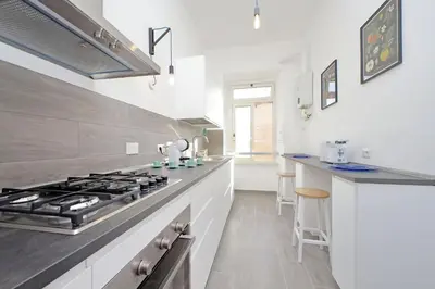 a kitchen with a stove and a counter top at New Comfortable 2 Br Della Vittoria by Halldis in Rome