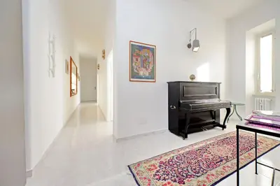 a living room with a piano and a rug at New Comfortable 2 Br Della Vittoria by Halldis in Rome