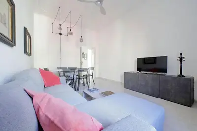 a living room with a blue couch and a television at New Comfortable 2 Br Della Vittoria by Halldis in Rome