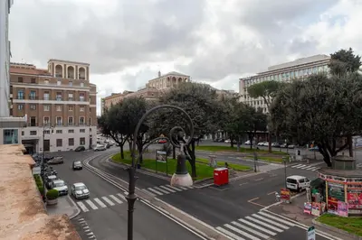 a city with a statue in the middle of a street at Ricky Home in Rome