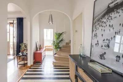 a living room with a table and a hallway at Elegant Penthouse with Terrace in Rome
