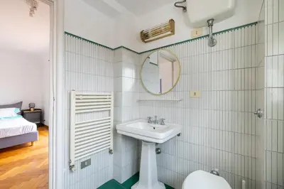 a bathroom with a sink and a mirror at Elegant Penthouse with Terrace in Rome