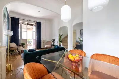a living room with orange chairs and a glass table at Elegant Penthouse with Terrace in Rome
