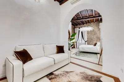 a living room with a white couch and a chair at NEW ROMAN Apartment - Rome Dream Home in Rome