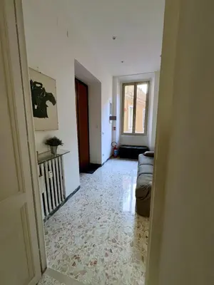 a living room with a couch and a window at Emilia's home in Rome