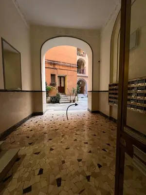 an empty hallway with an archway in a building at Emilia's home in Rome
