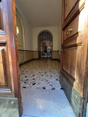 an empty room with a door and a tile floor at Emilia's home in Rome