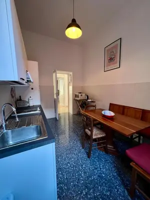 a kitchen with a sink and a wooden table at Emilia's home in Rome