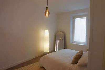 a bedroom with a bed and a lamp and a window at Lussuosa Casa nel cuore di Trastevere in Rome
