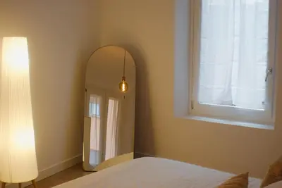 a bedroom with a mirror next to a window at Lussuosa Casa nel cuore di Trastevere in Rome