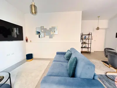 a living room with a blue couch and a tv at Lussuosa Casa nel cuore di Trastevere in Rome