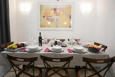 a dining room table with a table set with wine glasses at Thebestinrome Piazza del Popolo - Vico in Rome