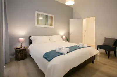 a bedroom with a large bed with towels on it at Thebestinrome Piazza del Popolo - Vico in Rome