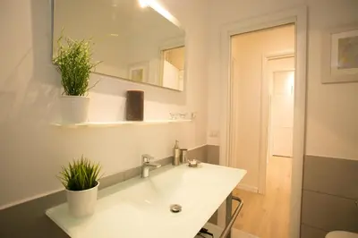 a bathroom with a sink and a mirror and plants at Thebestinrome Piazza del Popolo - Vico in Rome