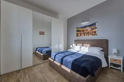 a bedroom with two beds and a painting on the wall at Luxury view on St Peter Basilica in Rome