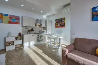 a living room with a couch and a kitchen at Luxury view on St Peter Basilica in Rome