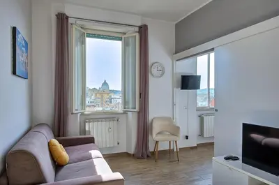 a living room with a couch and a large window at Luxury view on St Peter Basilica in Rome