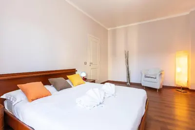 a bedroom with a large white bed and a chair at Altavilla by Rental in Rome in Rome