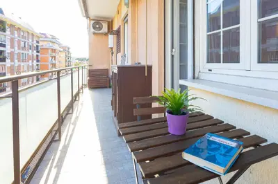 a book sitting on a wooden bench on a balcony at Altavilla by Rental in Rome in Rome