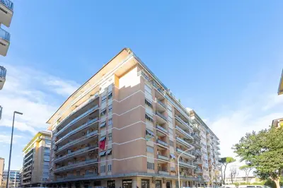 a tall apartment building in a city at Altavilla by Rental in Rome in Rome