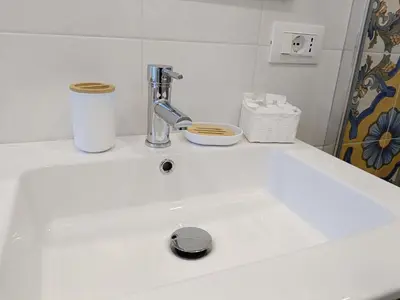 a bathroom with a sink and a toilet and a mirror at San Peter Vatican City quiet and lovely apartment in Rome
