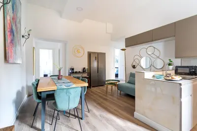 a kitchen and a living room with a table in a room at iFlat Brand New & Modern Central Station apt in Rome