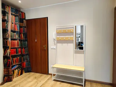 a room with a book shelf and a bench at La Casetta Battistini in Rome