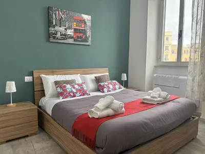 a bedroom with a bed with towels on it at Re Di Roma Retreat in Rome