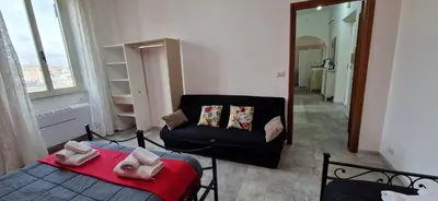 a bedroom with a bed and a chair and a mirror at Re Di Roma Retreat in Rome