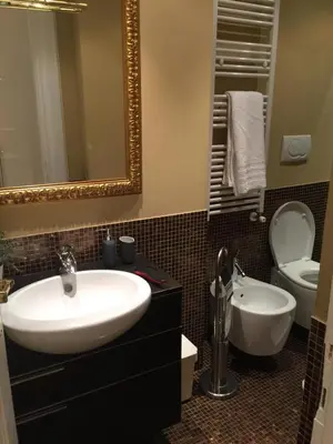 a bathroom with a sink and a toilet and a mirror at Angelo ai Musei Vaticani studio in Rome