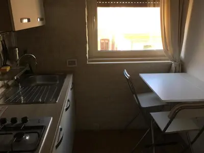 a kitchen with a sink and a stove and a window at Angelo ai Musei Vaticani studio in Rome