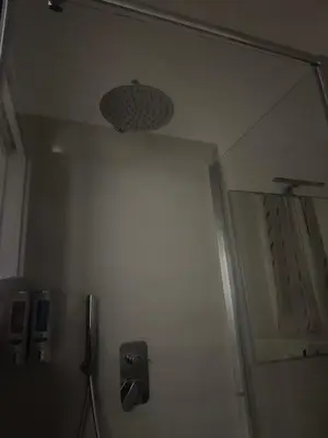 a bathroom with a mirror next to a door at Munsi Vatican House in Rome