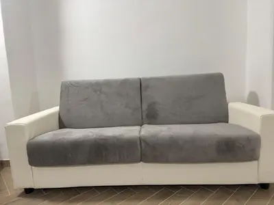 a white couch with a gray pillow on it at Munsi Vatican House in Rome