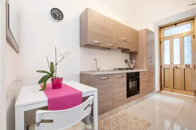 a kitchen with a table with a pink towel on it at Cozy House near Termini Station - San Lorenzo in Rome