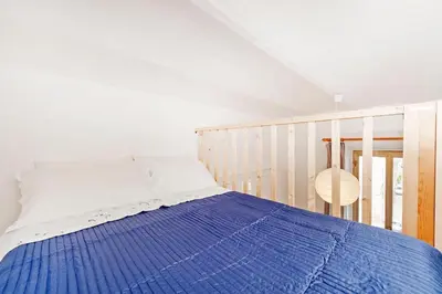 a bedroom with a bed with a blue blanket at Cozy House near Termini Station - San Lorenzo in Rome