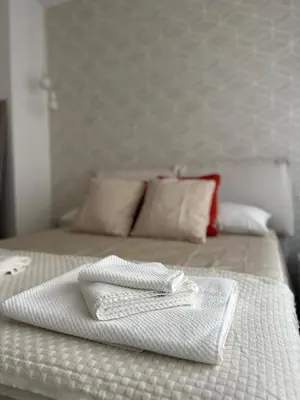 a bed with a white towel on top of it at Bliss House near Vatican City in Rome
