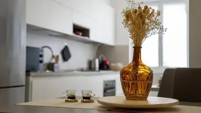 a vase with flowers in it sitting on a table at Bliss House near Vatican City in Rome
