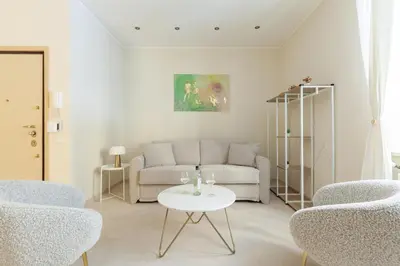 a living room with a couch and a table at Hostly-The Happya Charme Suite in Rome