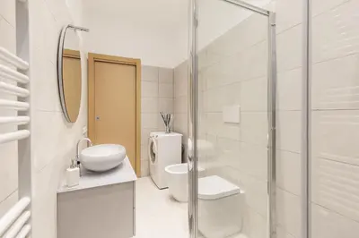 a bathroom with a toilet and a sink and a shower at Hostly-The Happya Charme Suite in Rome