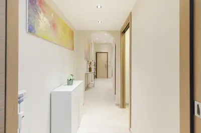 a hallway of a home with a painting on the wall at Hostly-The Happya Charme Suite in Rome